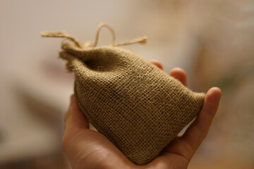 Coffee textil sack bag in hand of barista