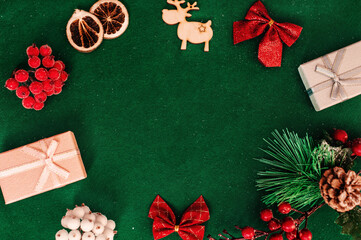 Christmas composition frame for text. Flat lay, top view - greeting card template christmas and New Year. Christmas decorations on a green background