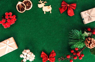 Christmas composition frame for text. Flat lay, top view - greeting card template christmas and New Year. Christmas decorations on a green background