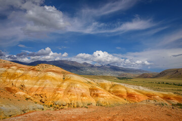 Amazing natural phenomenon-Martian landscapes in the Altai mountains. Multicolored rocks against a blue sky with white clouds. Futuristic panoramic picture, background image. Mars.