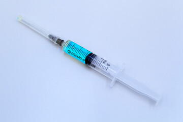 Syringe, protective mask and electronic thermometer on a grey background.Vaccination against the virus.