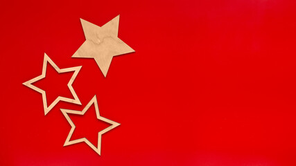 Wide banner Red background with three flat wooden stars.