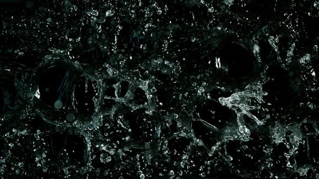 Water splashing on black background, super slow motion. Filmed on high speed cinema camera, 1000 fps.