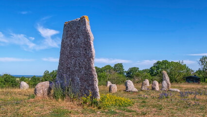 Viking stone ship burial and old windmill in Oland island by beautiful day, Gettlinge, Sweden © Elenarts