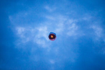 Floating lanterns in the evening sky.
