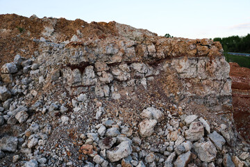 textures of various clay layers underground in  clay quarry after  geological study of  soil. colored layers of clay and stone in  section of  earth, different rock formations and soil layers.