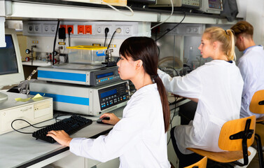 Portrait of diligent friendly group of European and Chinese scientists working together at biochemical laboratory