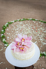 Fototapeta na wymiar Wedding Cake with Flowers on Top.