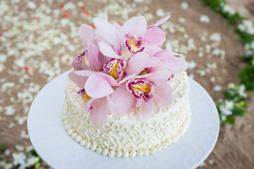 Fototapeta na wymiar Wedding Cake with Flowers on Top.