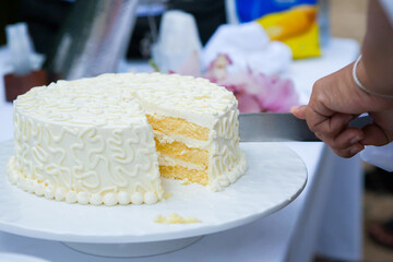 wedding cake is cut into pieces.