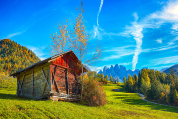 Autumn scene of  Santa Magdalena famous Italy Dolomites village view in front of the Geisler or Odle Dolomites Group mountain rocks.