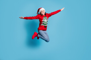 Fototapeta na wymiar Photo portrait of girl jumping high up making plane with hands isolated on pastel light colored background