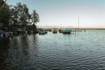 Fototapeta na wymiar Fishing village with boats by the pier in Russia.