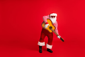 Full length photo of pensioner old man play guitar entertain party wear santa costume suspenders...