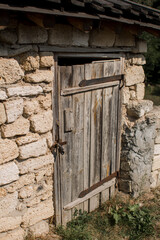 old wooden door in a stone wall locked