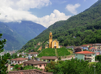 aerial view from bellinzona castle, view of San Sebastian yellow church on the hill surrounded by grapevine