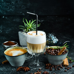 Coffee set: coffee beans, latte coffee and cappuccino. On a black background. Top view.