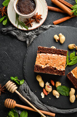 Peanut chocolate cake. Dessert. On a black background. Top view.