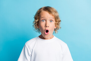 Portrait of boy feel astonished open mouth wear casual style clothes isolated over blue color background - obrazy, fototapety, plakaty