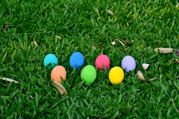 Variety of colorful Easter eggs on grass, selective focus