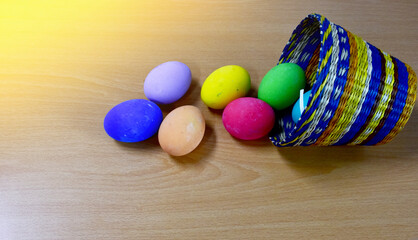 Easter eggs in the Basket on Wooden Table at morning day.