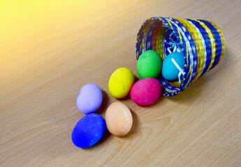 Easter eggs in the Basket on Wooden Table at morning day.