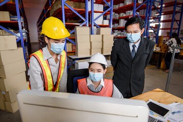 Engineer woman and businessman wearing a hardhat standing cargo at goods or merchandise warehouse and check control loading from Cargo freight ship for import and export. Teamwork successful concept.
