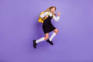 Fototapeta na wymiar Full length body size view of her she nice attractive cheerful crazy overjoyed small little girl jumping running late lesson isolated bright vivid shine vibrant lilac violet purple color background