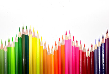 Many Color pencils isolated on white background close up. Color pencils for drawing as a background