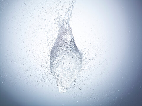 Exploding water balloon on white background