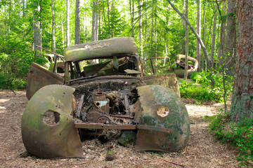 Car wreck abandoned in the woods.