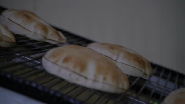 Fresh Arabic bread coming out of the oven