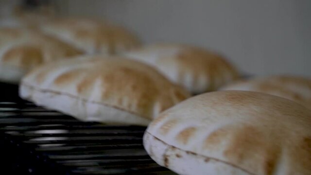 Fresh Arabic bread coming out of the oven