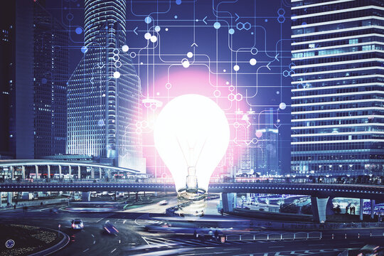 Multi exposure of bulb hologram drawing and cityscape background. Concept of idea.