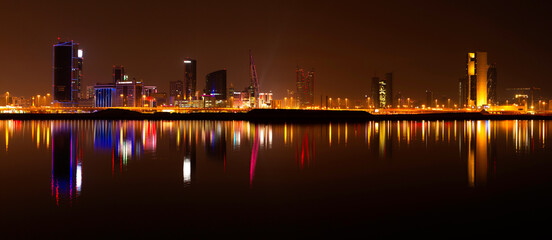 Fototapeta na wymiar A beautiful view of Bahrain skyline during night and its reflection on water