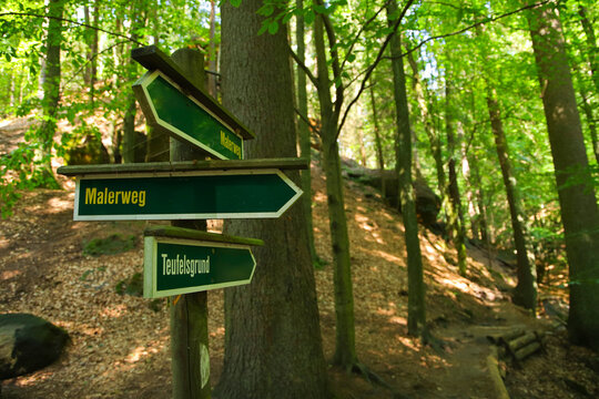 Guide post "Malerweg" (painters path) and "Teufelsgrund" on a hiking trail in elbe sandstone mountains near the town Wehlen -  Saxon Switzerland, Germany