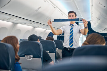 Handsome steward training safety prior procedures to flight take off © Svitlana