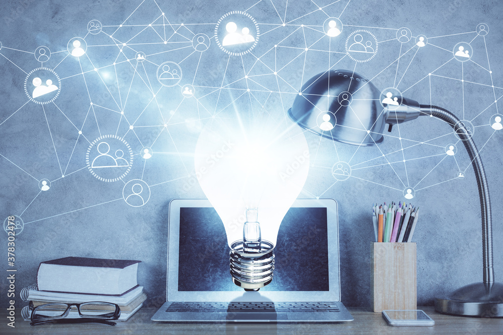 Poster computer on desktop in office with bulb icon hologram. double exposure. concept of idea.