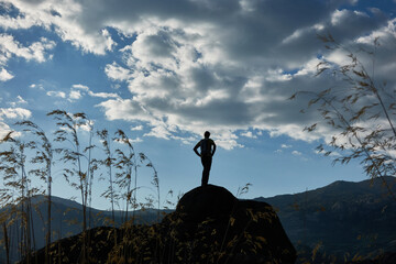 A mountaineer contemplates La Pedriza from the top of a rock in the Sierra de Guadarrama National Park. Madrid's community. Spain.