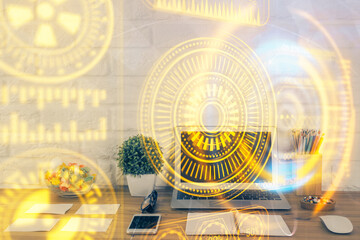 Fototapeta premium Computer on desktop in office with technology theme hologram. Double exposure. Tech concept.