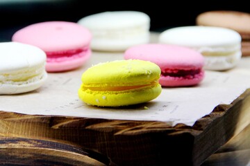 multicolored macaroons in the coffee shop window, selective focus
