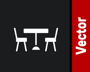 White Picnic table with chairs on either side of the table icon isolated on black background. Vector.