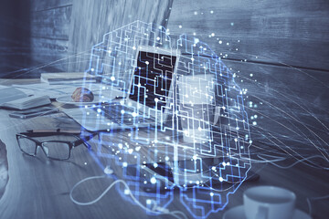 Multi exposure of work table with computer and brain hologram. Brainstorm concept.