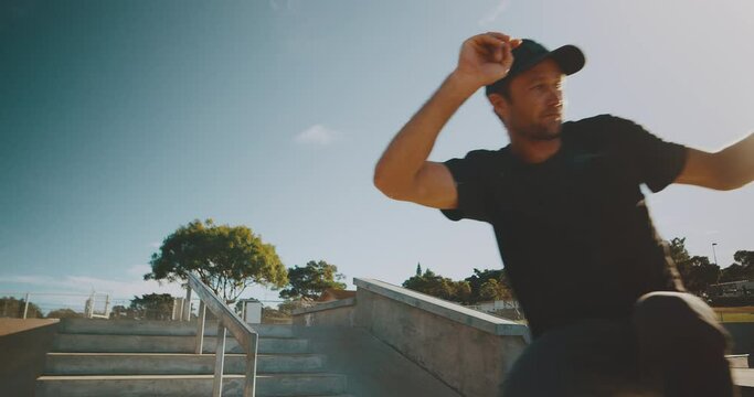 Skateboarder grinding rail in the park