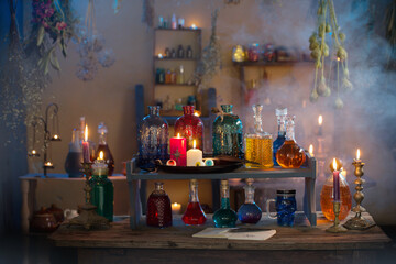 magic potions in witch's house with burning candles at night
