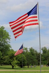 american flag in the wind at a Cemetery in Hutchinson Kansas USA on Memorial Day.
