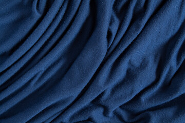 Texture of crumpled blue satin fabric.