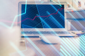 Financial graph colorful drawing and table with computer on background. Double exposure. Concept of...