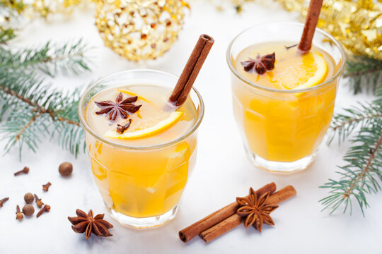 Mulled white wine with spices, orange slices on New year and Christmas background. Copy space. Top view.
