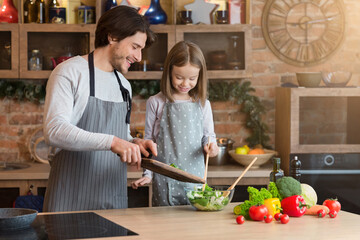 Family Cooking. Cheerful Dad And Little Daughter Preparing Healthy Lunch Together